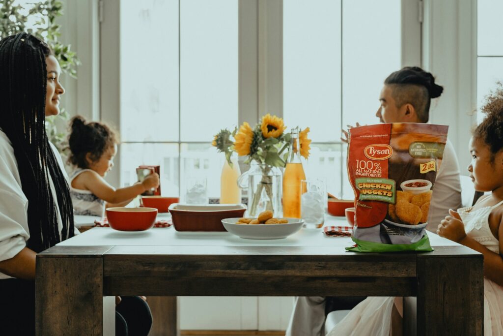 woman in black tank top sitting on chair in front of table with orange ceramic bowl